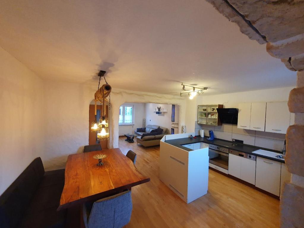 a kitchen and a living room with a wooden table at Nephelin in Weil am Rhein