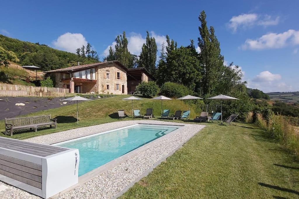 a swimming pool in the yard of a house at Gîte de luxe 4 étoiles in Saint-Antoine