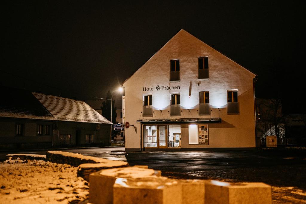 a building with a sign on the side of it at night at Hotel Prácheň in Horažďovice