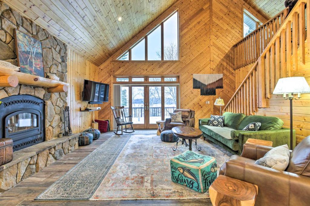 a living room with a fireplace in a log cabin at Crandon Cabin Getaway with Boat Dock and Deck! in Crandon