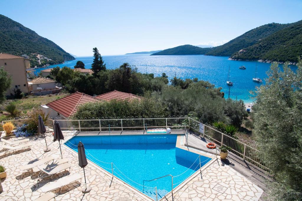 a swimming pool with a view of a lake at Rouda Village in Mikros Gialos