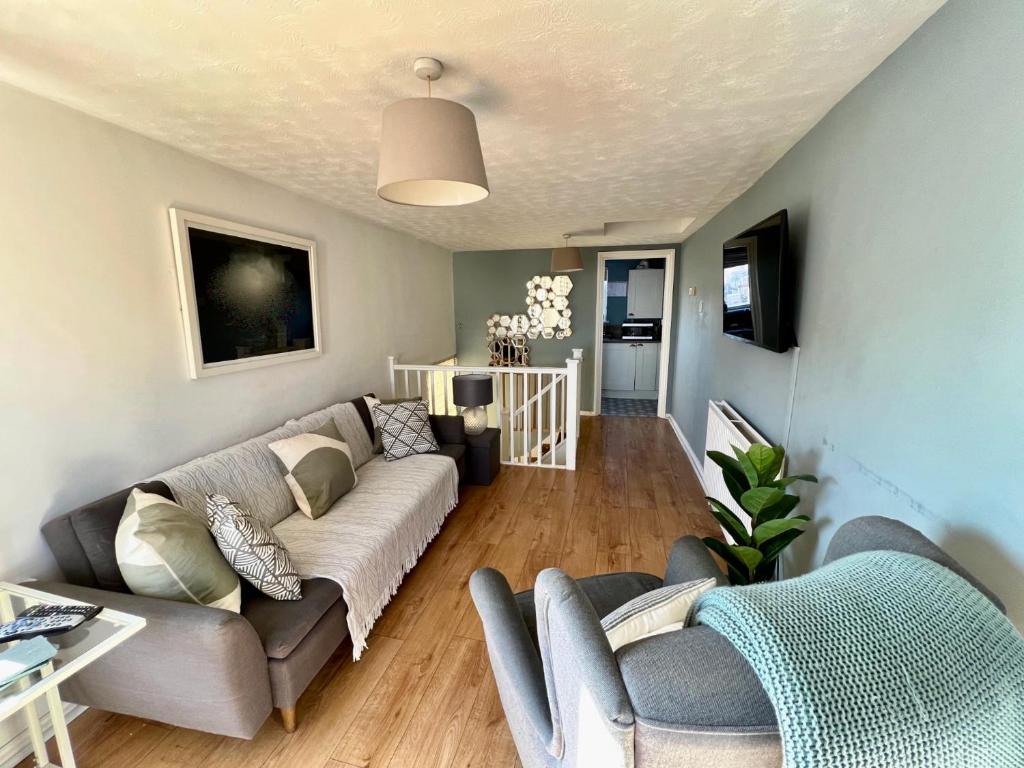 a living room with a couch and a table at Viewing Room, seaview 30 seconds from beach in Broadstairs