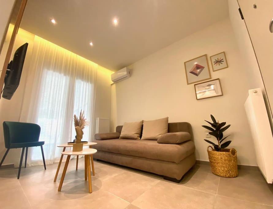 a living room with a couch and a table at Piraeus Apartment for rent in Piraeus