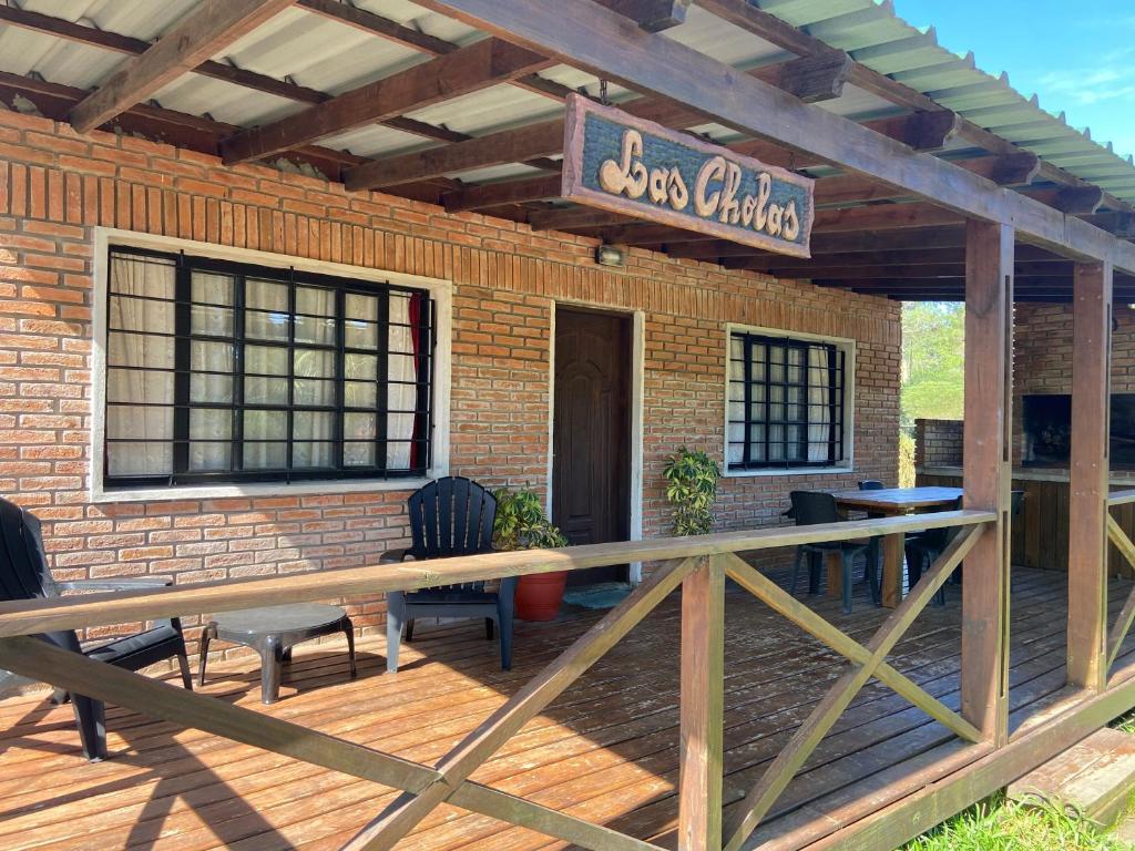 a brick building with a deck with a restaurant at Las Cholas in La Paloma