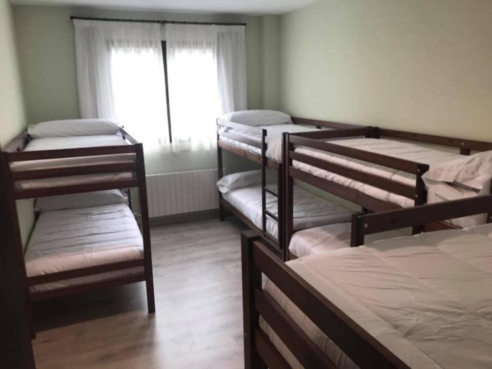 A bed or beds in a room at Las Ermitas de Vallada
