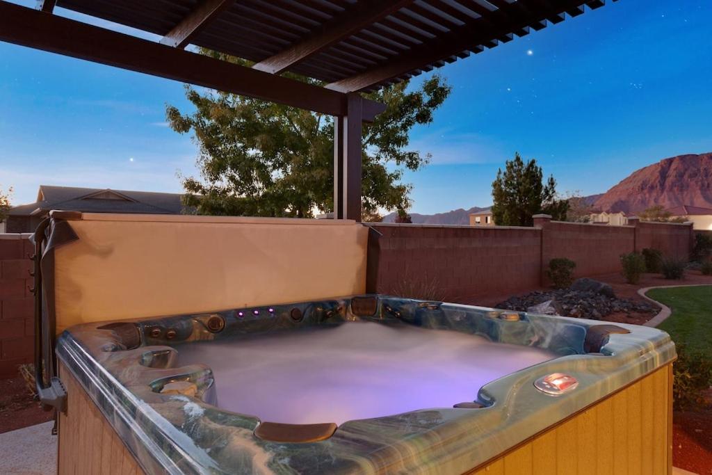 a jacuzzi tub in a backyard with a roof at Paradise Village 117 Private Hot Tub, 2 PS4s, Telescope, Observation Balcony, Games and More in Santa Clara