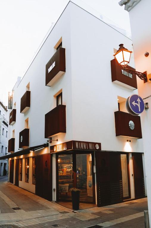 a store front of a building with a sign on it at Mamma Mia Hotel Boutique - Only Adults in Tossa de Mar
