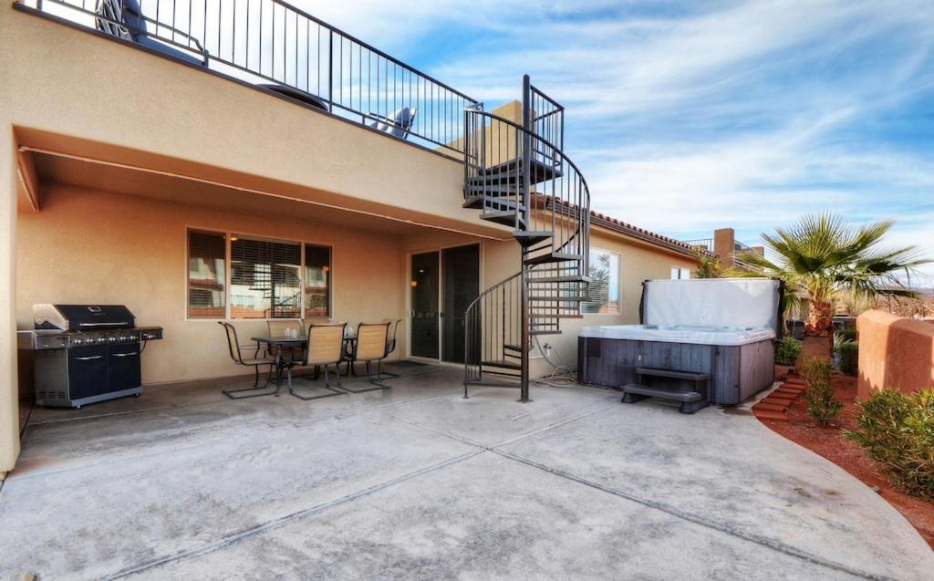 a patio with a spiral staircase and a grill at Paradise Village 121 Private Hot Tub, X BOX, 5 Bikes, Bag Toss, Pack n' Play, Games, Mountain Views, and More in Santa Clara