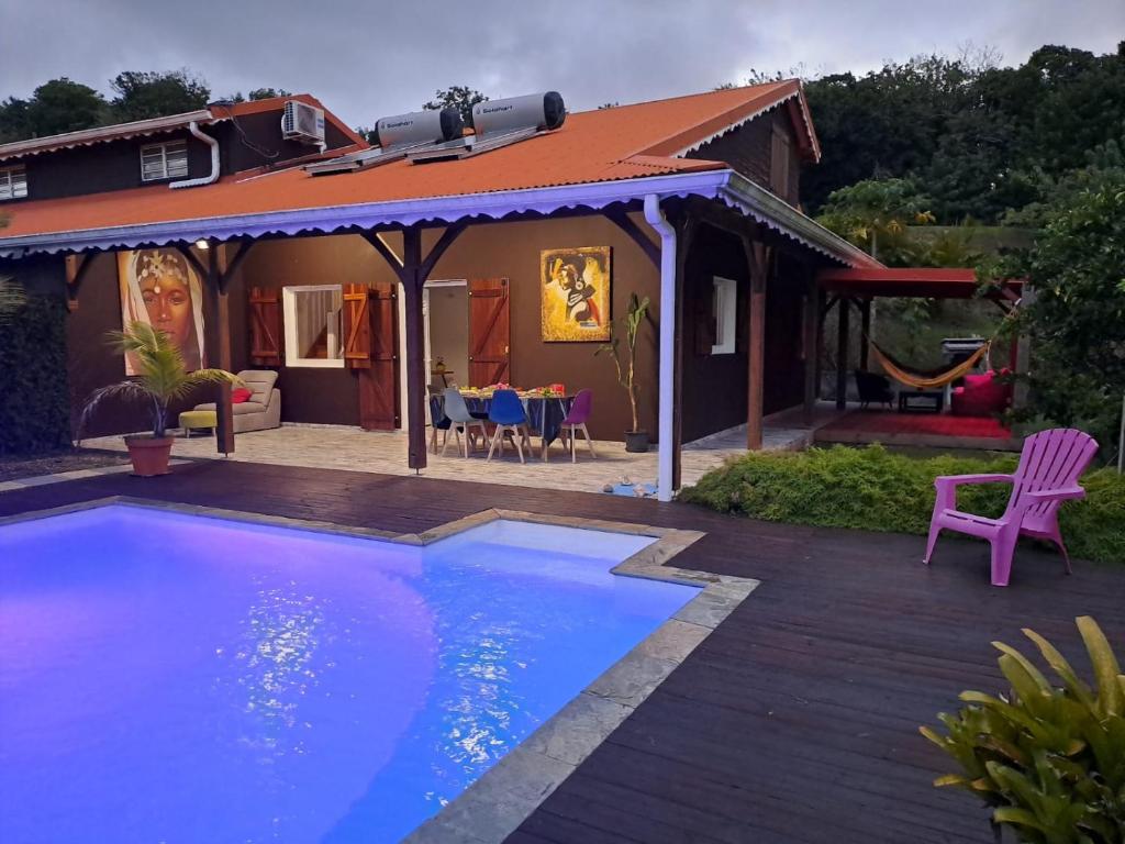 a house with a swimming pool in a yard at Villa Tourmaline in Le Lorrain