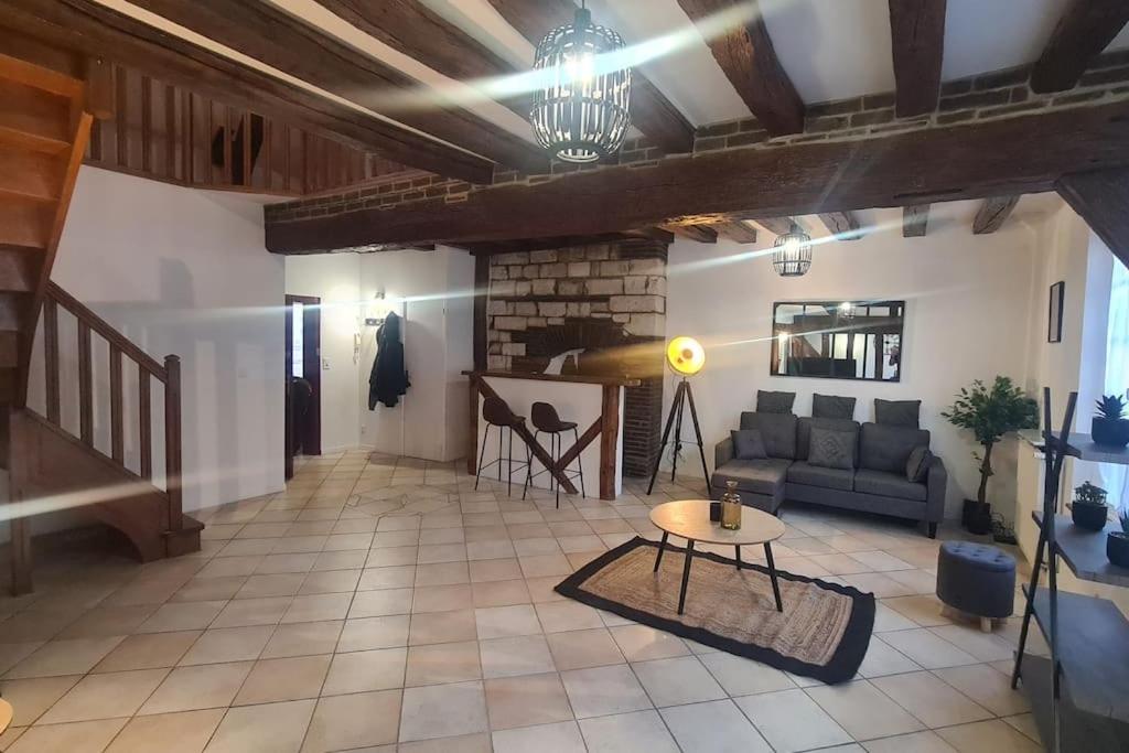 a living room with a couch and a table at Duplex de Prestige in Troyes