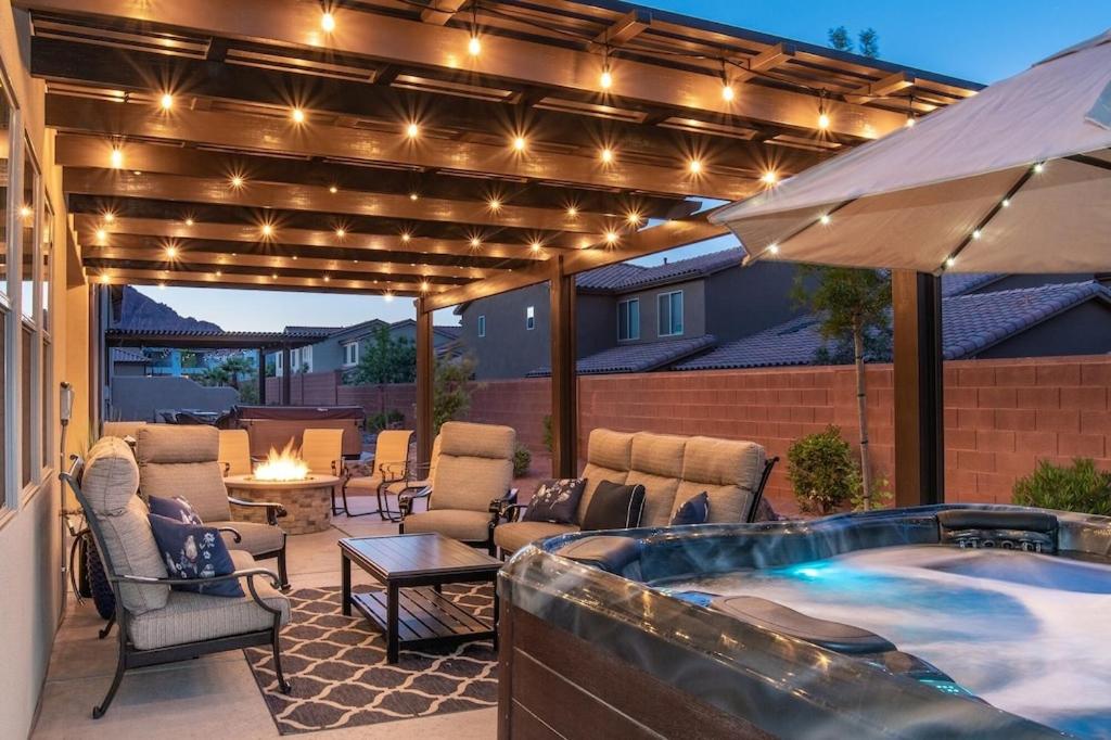 a patio with a hot tub and a deck with lights at Paradise Village 95 Kid Friendly Home, Private Hot Tub, Nintendo Switch, Air-Hockey, Resort Style Pool and Water Park in Santa Clara