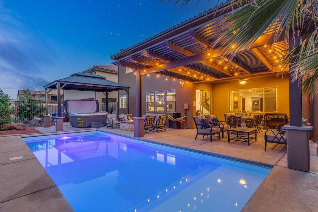 a swimming pool in front of a house at 96 PV Luxury Getaway with Private Hot Tub, Ping Pong, Community Pool, Water Park and Lazy River in Santa Clara