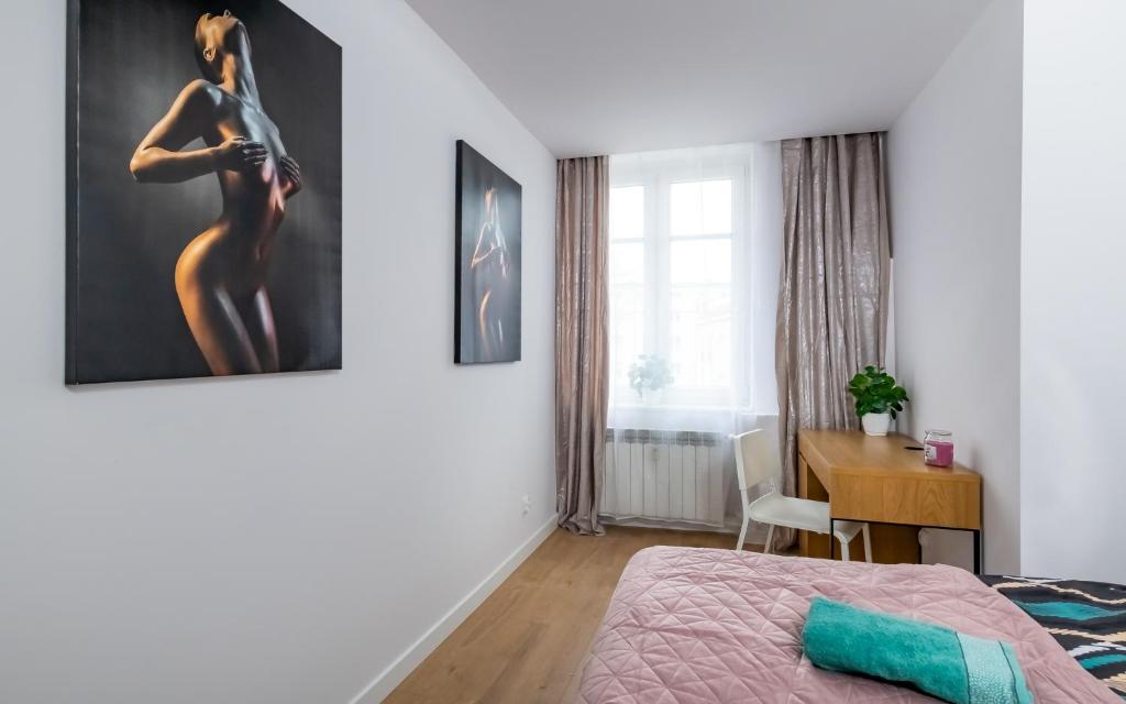 Posteľ alebo postele v izbe v ubytovaní Waryńskiego Jacuzzi FamilyRoom