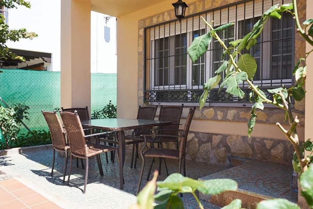 a patio with a table and chairs and a building at CASA PUERTA DEL BOROSA in Coto Ríos