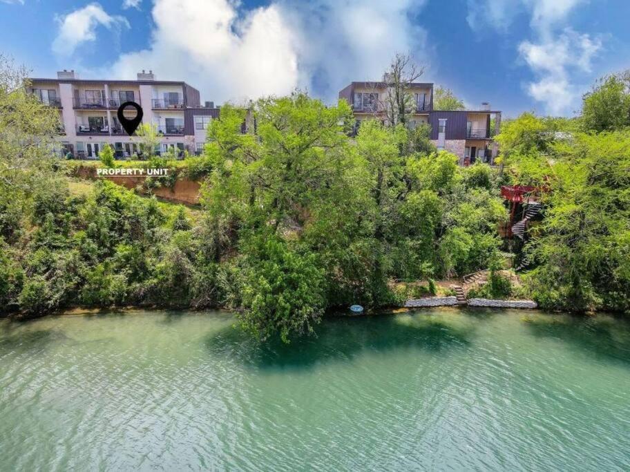 an aerial view of a river with trees and buildings at Guadalupe Getaway in New Braunfels