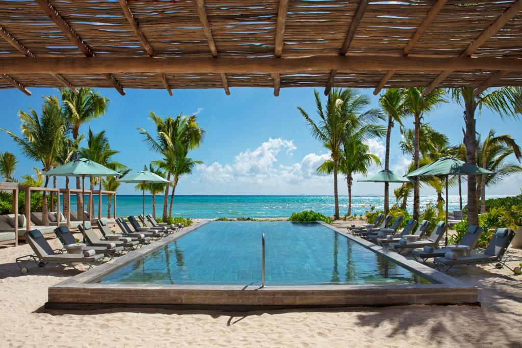 a pool on the beach at a resort at Impression Moxché by Secrets - Adults Only in Playa del Carmen