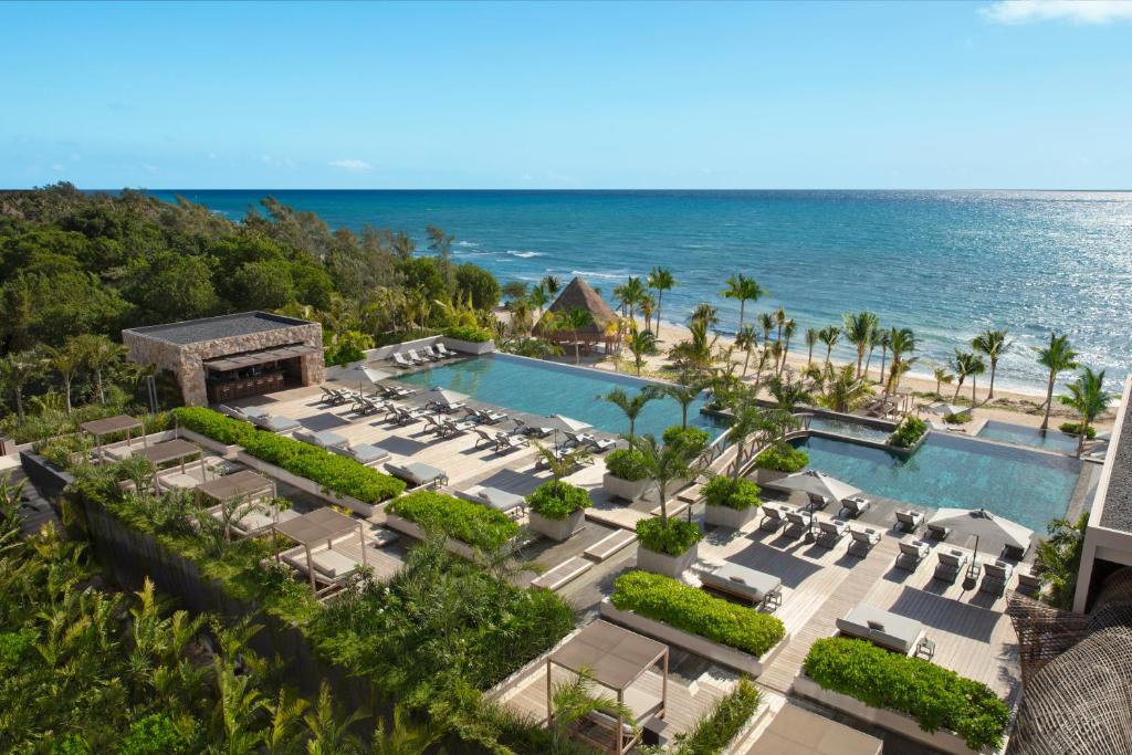 an aerial view of a resort with a pool and the ocean at Impression Moxché by Secrets - Adults Only in Playa del Carmen