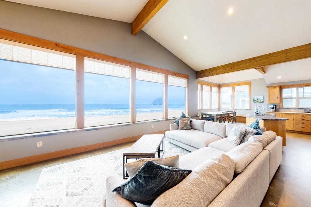 a living room with two couches and a view of the ocean at Pacific City Ocean Front Escape in Pacific City