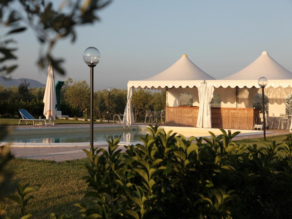 a tent in a park with a swimming pool at Agriturismo Il Giglio di S. Antonio in Montemassi