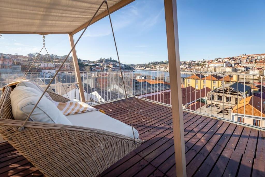a porch with a hammock on a balcony at Terrace Douro in Vila Nova de Gaia