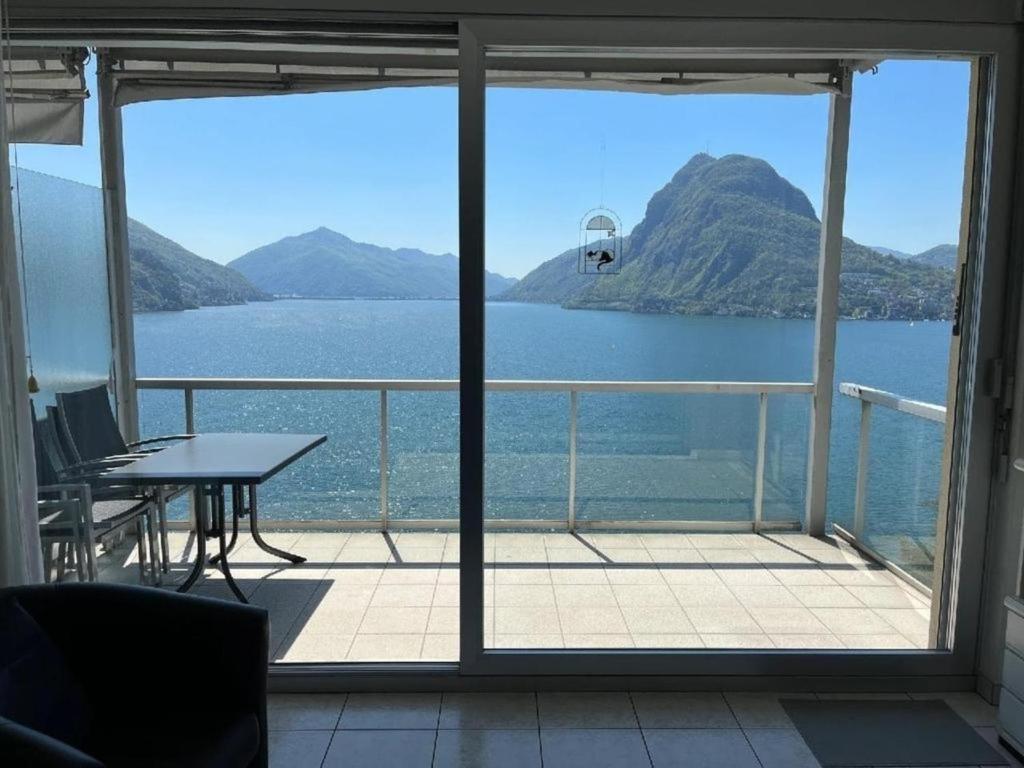 a view of a balcony with a view of the water at Apartment Eldorado View in Lugano