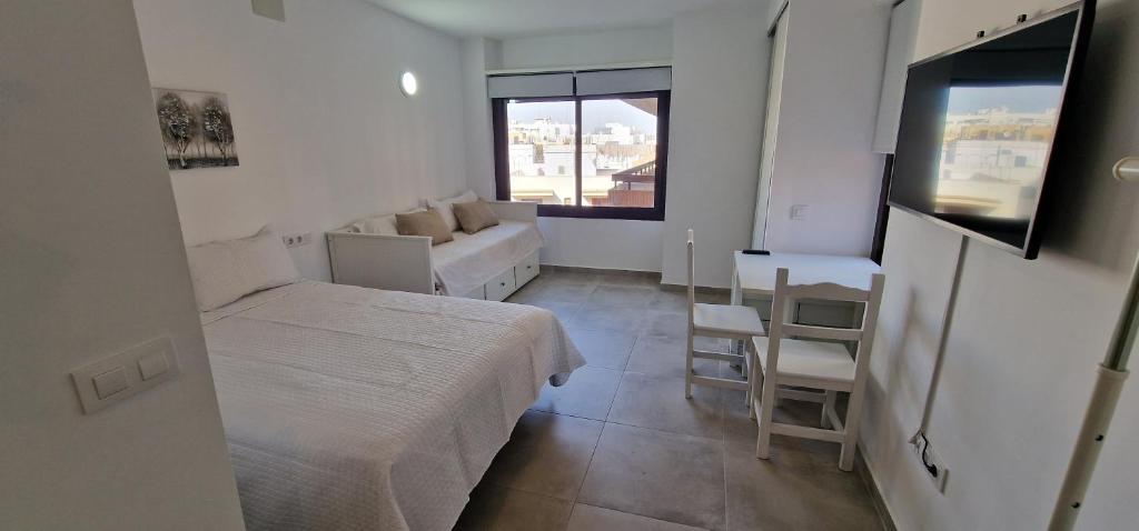 a small bedroom with a bed and a couch at Top Triana Sevilla in Seville