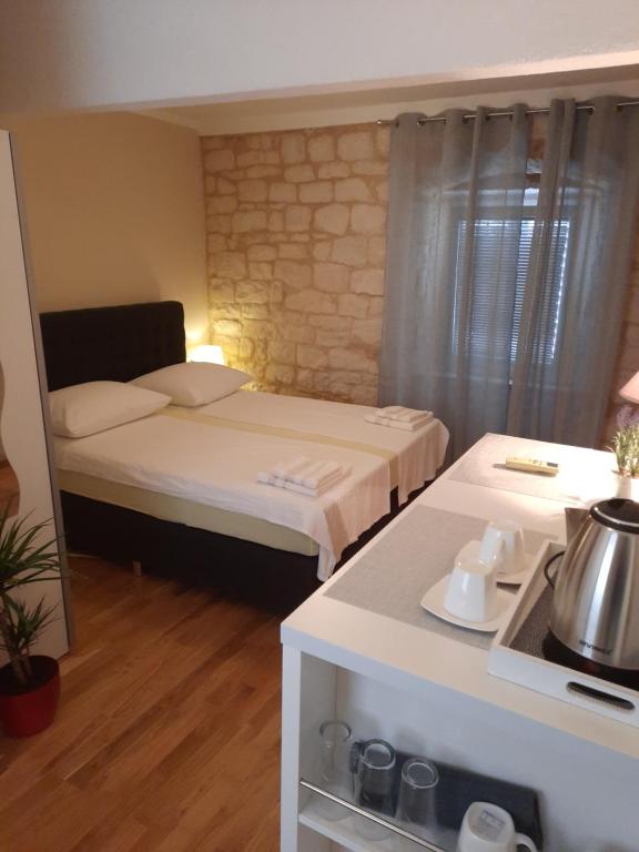 a small room with a bed and a kitchen at Room No3 in Trogir