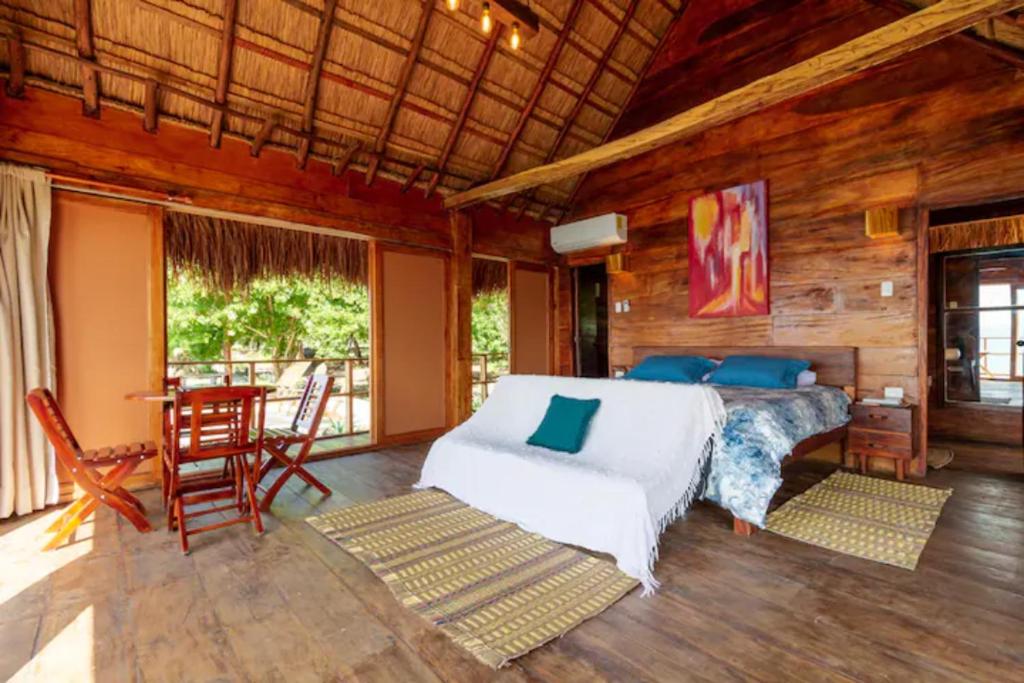 a bedroom with a bed and a table and chairs at Pamaduih - Suite Above the Sea in Cartagena de Indias