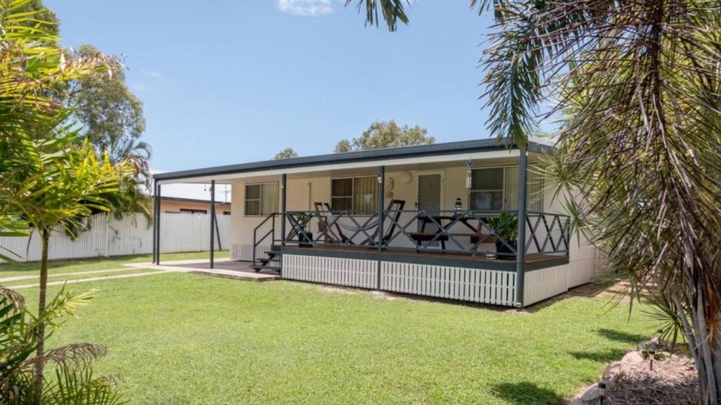 a house with a screened in porch with a yard at Idle Days Beach House in Horseshoe Bay