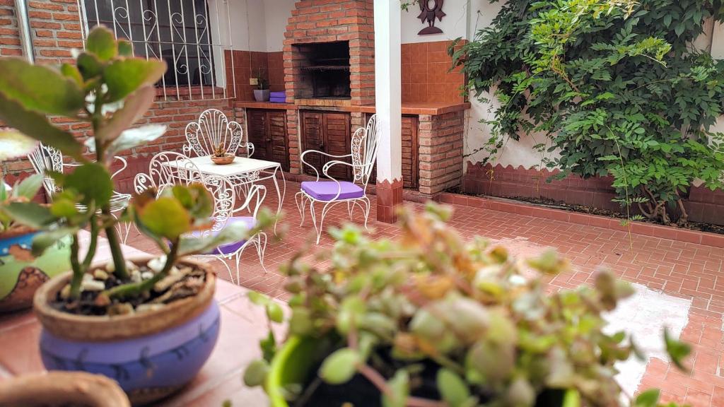 a patio with chairs and a table with plants at Casa Kuyay in San Salvador de Jujuy