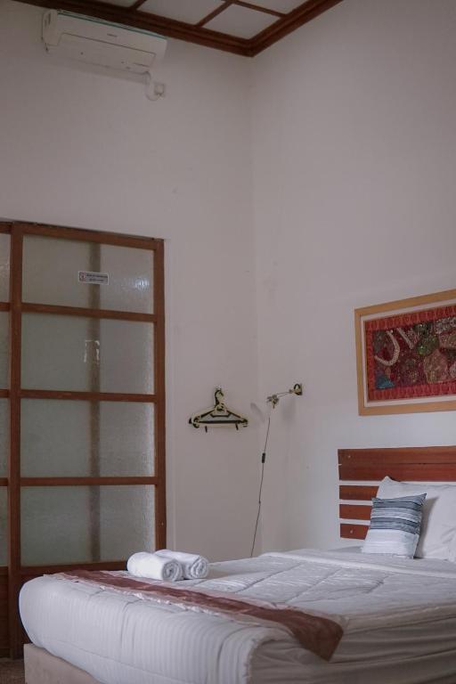 Postel nebo postele na pokoji v ubytování Augustina Home