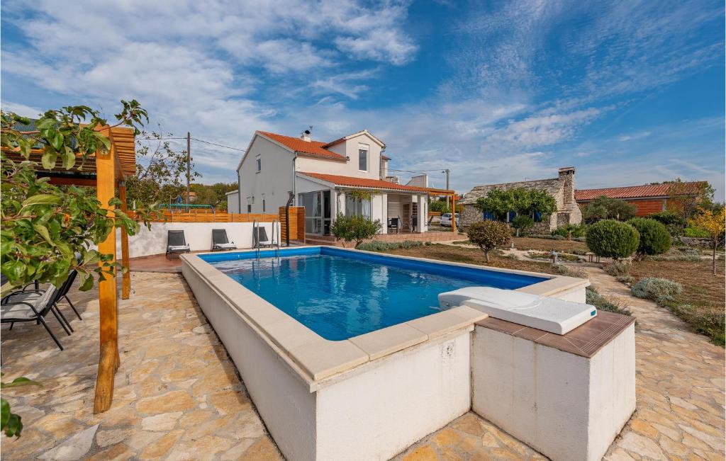 a swimming pool in front of a house at 2 Bedroom Amazing Home In Krkovic in Lađevci