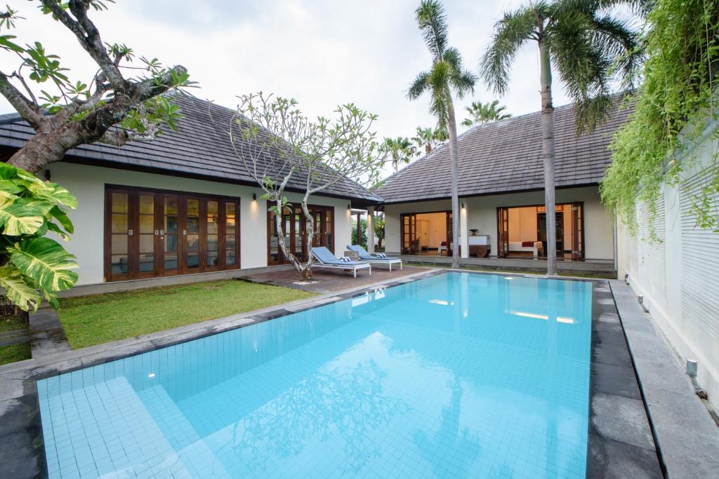 an image of a swimming pool in front of a house at Nunia Boutique Villa in Seminyak