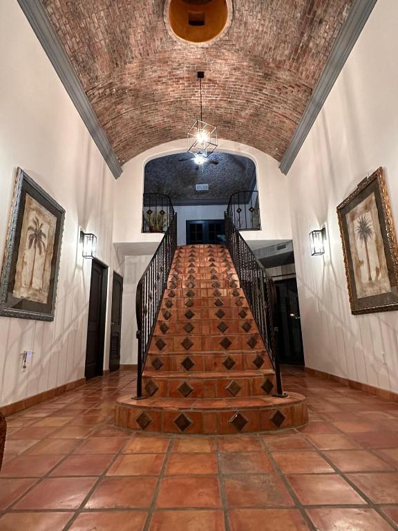 a hallway with a wooden staircase in a building at LUX 3 MASTER BDROOM ON SANDY BEACH w NO CLEAINING FEE in Puerto Peñasco
