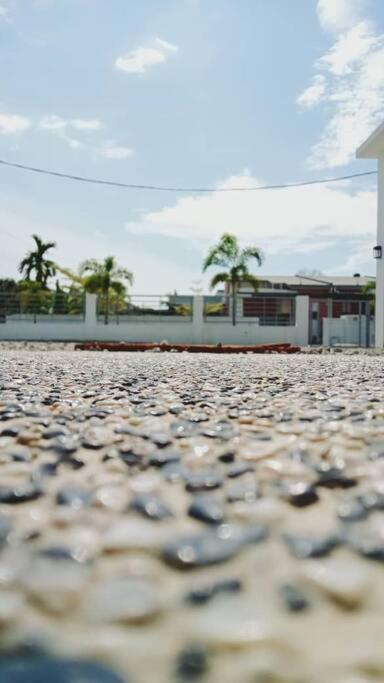a stone parking lot with a building in the background at The Second Homestay in Port Dickson