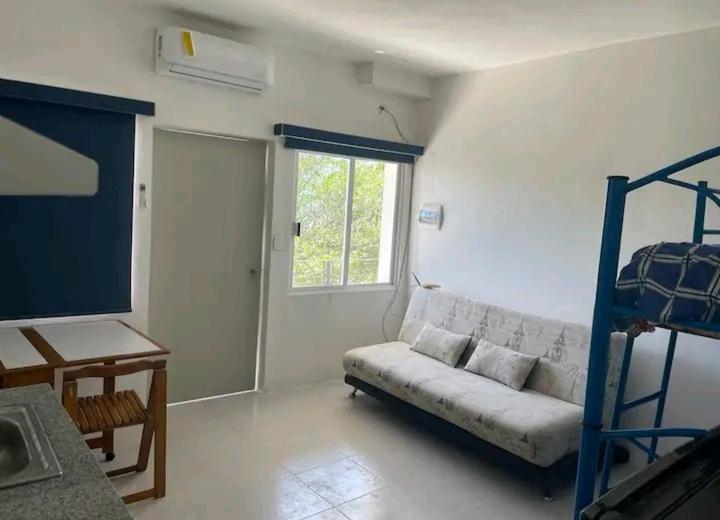 a living room with a couch and a bunk bed at Loft 203 in Acapulco