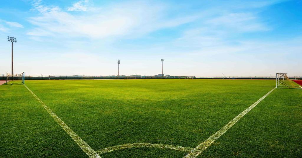 an empty soccer field with a soccer goal at ERTH Abu Dhabi Hotel in Abu Dhabi