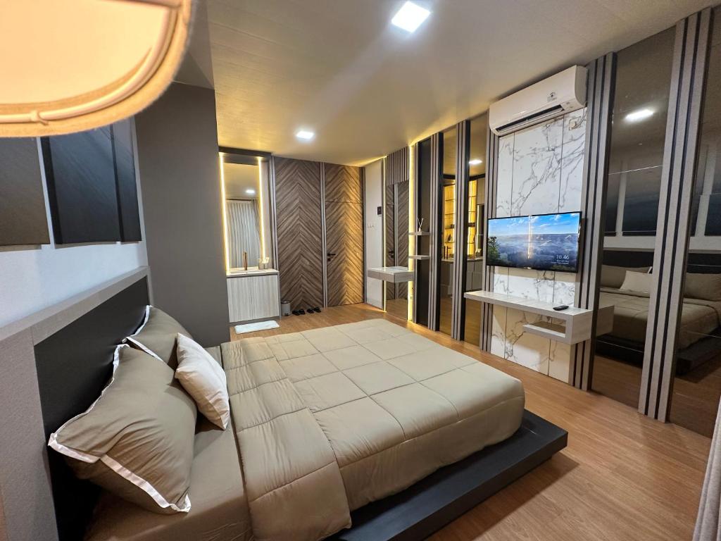 a bedroom with a large bed and a television at Deluxe Residence Kalibata 8 in Jakarta