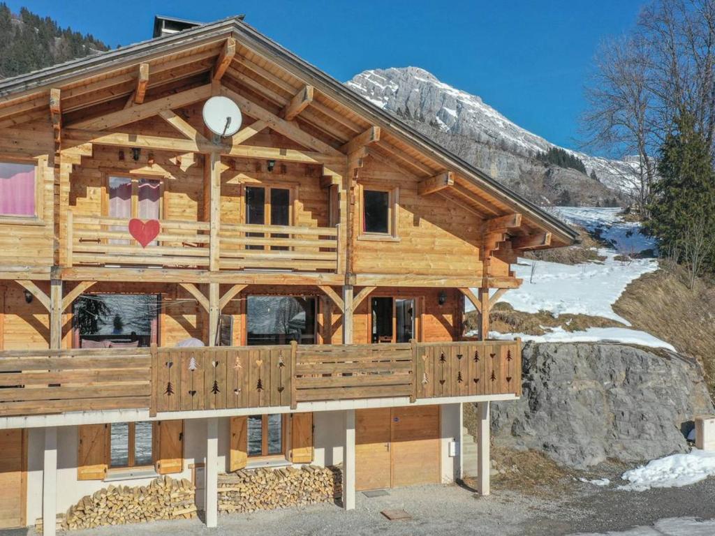 a log cabin in the mountains with snow at Chalet Le Grand-Bornand, 6 pièces, 12 personnes - FR-1-391-116 in Le Grand-Bornand