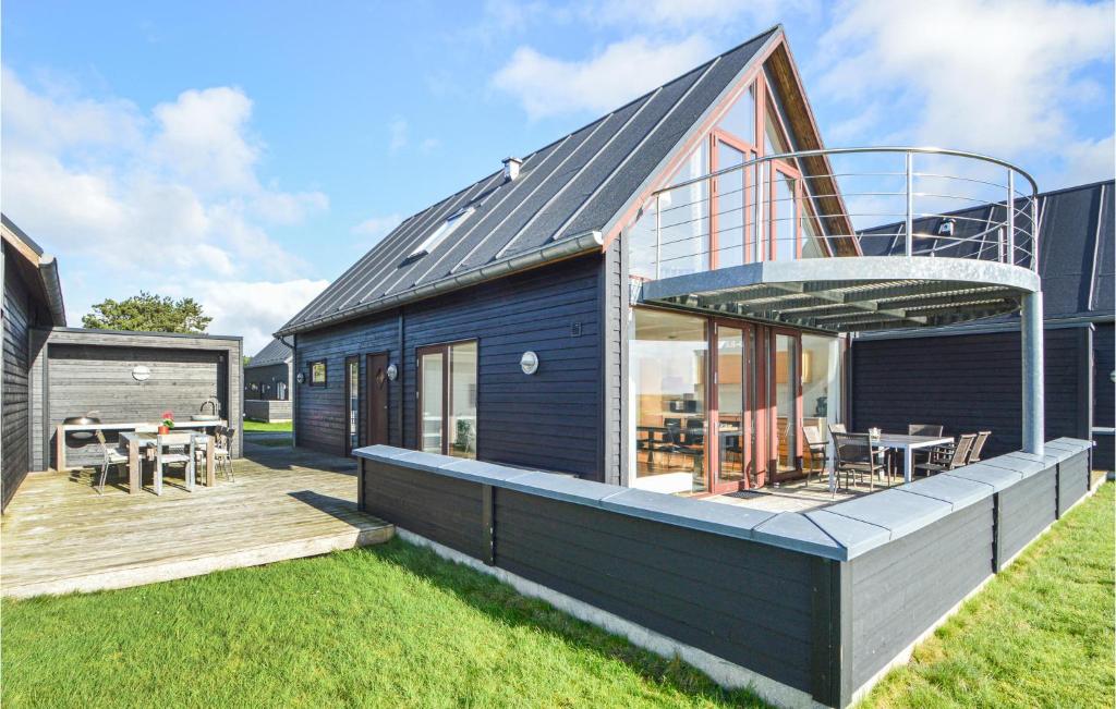 a house with a deck and a patio at 3 Bedroom Amazing Home In Rm in Rømø Kirkeby