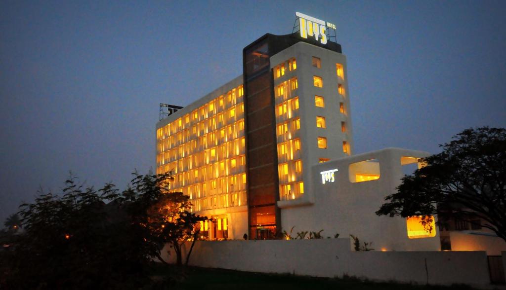 a tall building with lights on it at night at Keys Select by Lemon Tree Hotels, Kochi in Cochin