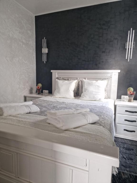 una camera da letto con un grande letto bianco con due cuscini di Onyx apartment a Puerto del Carmen