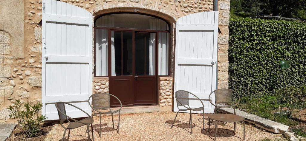 a group of chairs sitting in front of a door at Domaine Saint Bonnet in Puimoisson