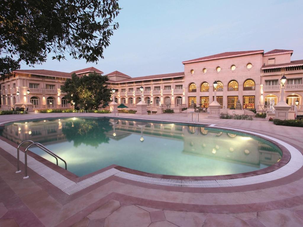 a large swimming pool in front of a building at Evershine Resort & Spa in Mahabaleshwar