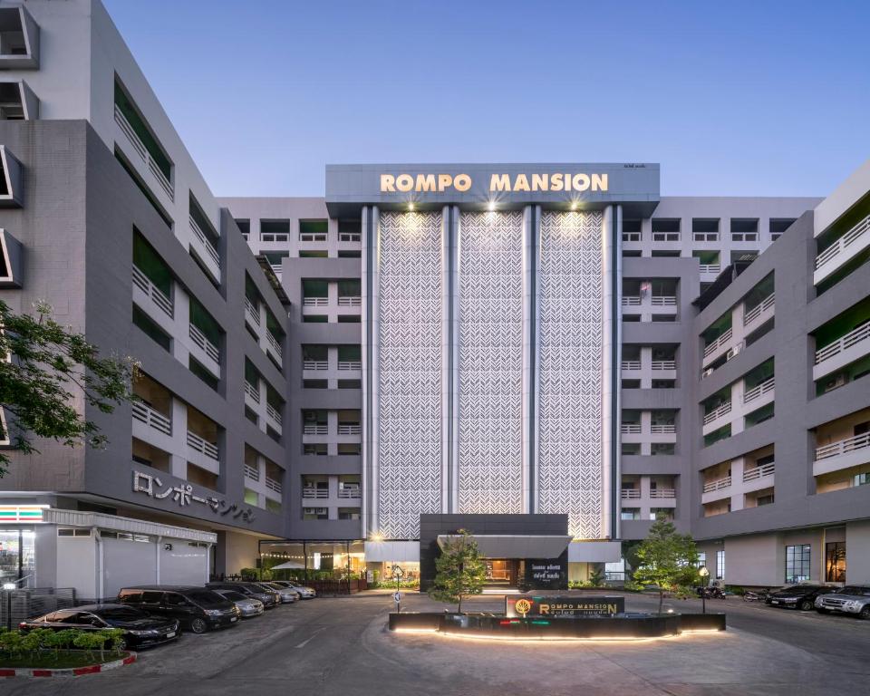 a building with a rompo management sign on it at At 115 Hotel By Rompo in Bangkok