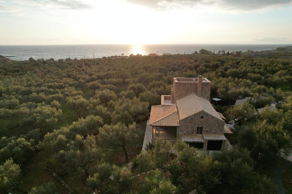 an aerial view of a stone house in the forest at Stylish Manihaus for a romantic adventure in Stoupa