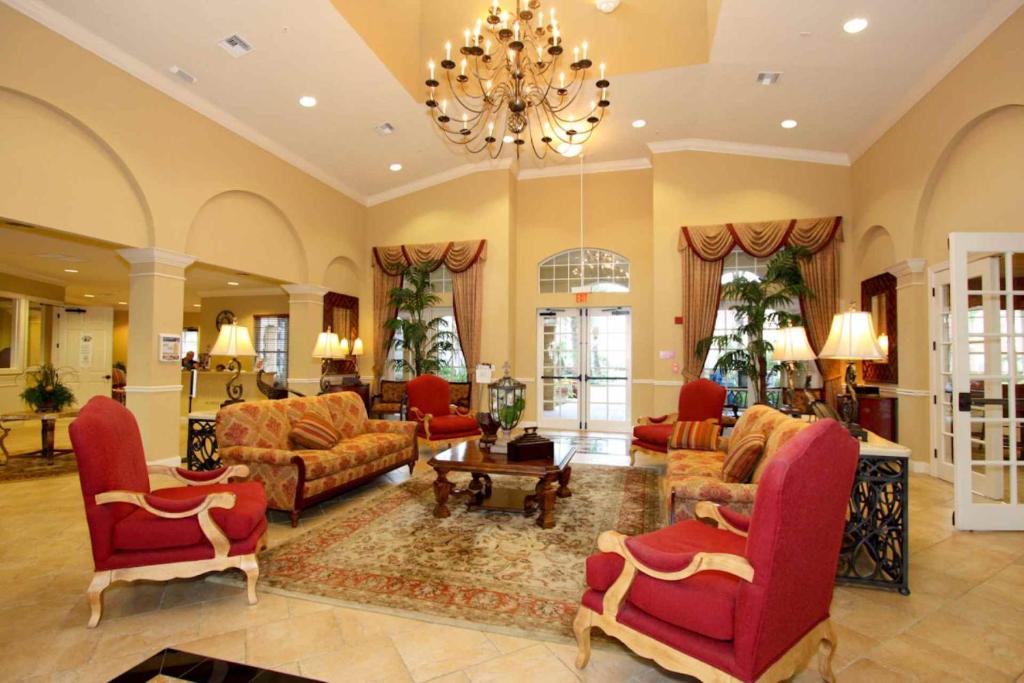 a large living room with red furniture and a chandelier at IT289 - Vista Cay Resort - 3 Bed 2 Baths Condo in Orlando