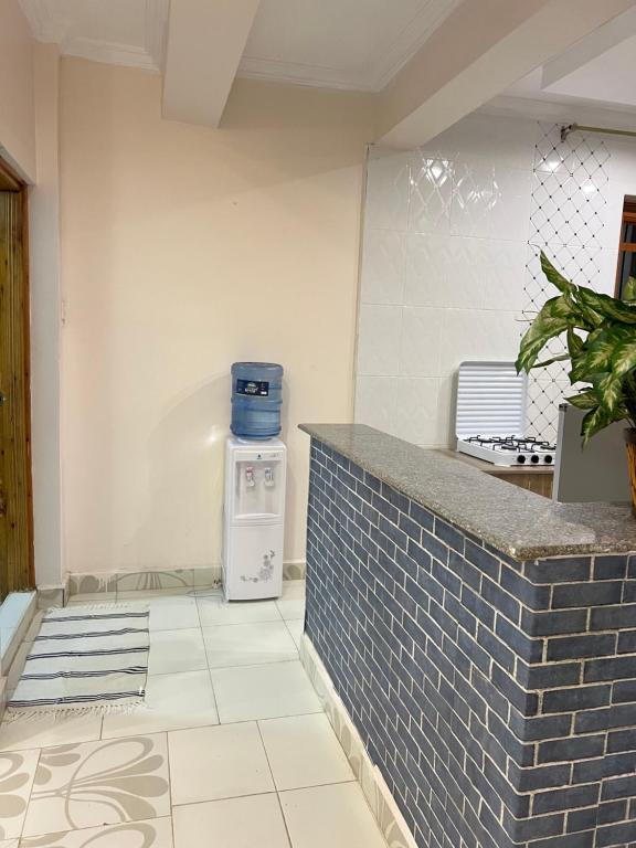 a kitchen with a brick counter and a blue appliance at Regency Stays in Eldoret