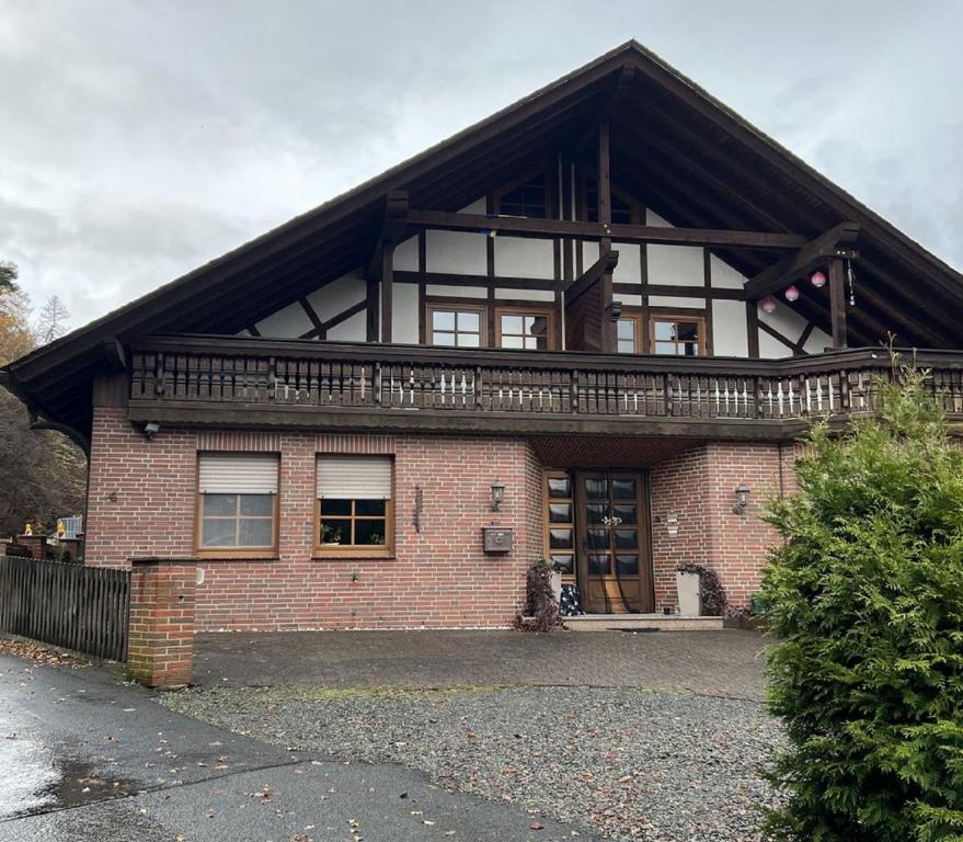 a brick house with a balcony on top of it at Ferienwohnung Schneider mit Balkon in Bad Laasphe