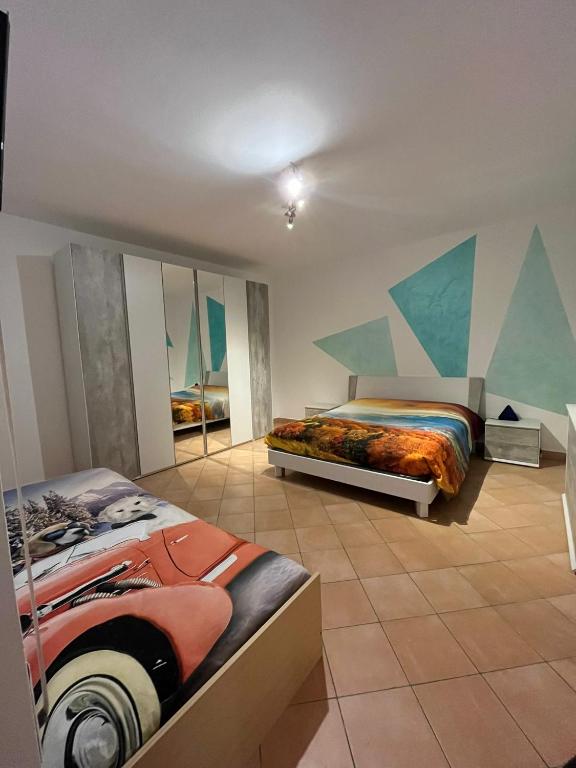 a bedroom with two beds and a painting on the wall at Un nido sul lago in Ranzanico